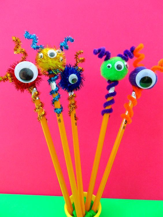 image shows a jar of pencils with toppers made out of colorful pom poms, googly eyes, and pipe cleaners.