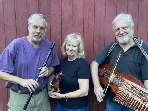 three performers holding a variety of instruments 