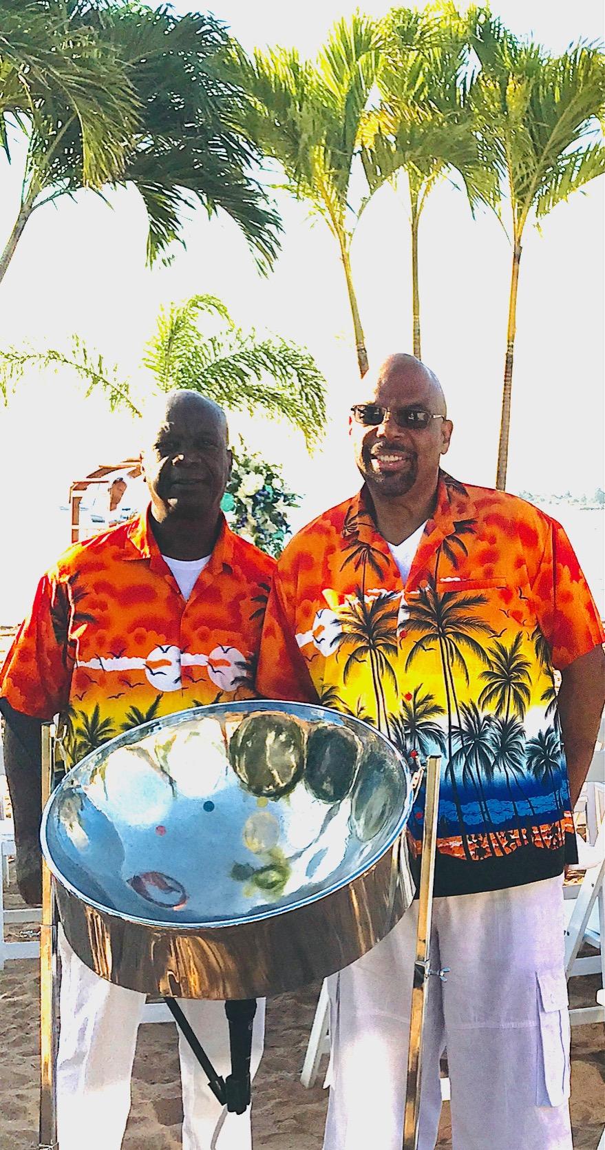 band wearing island shirts standing next to steel drums